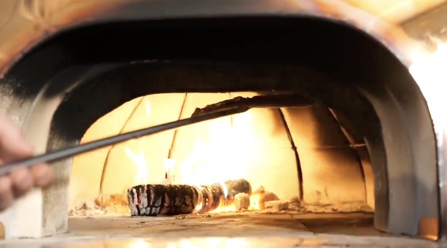 raise pizza to dome to finish wood fired pizza