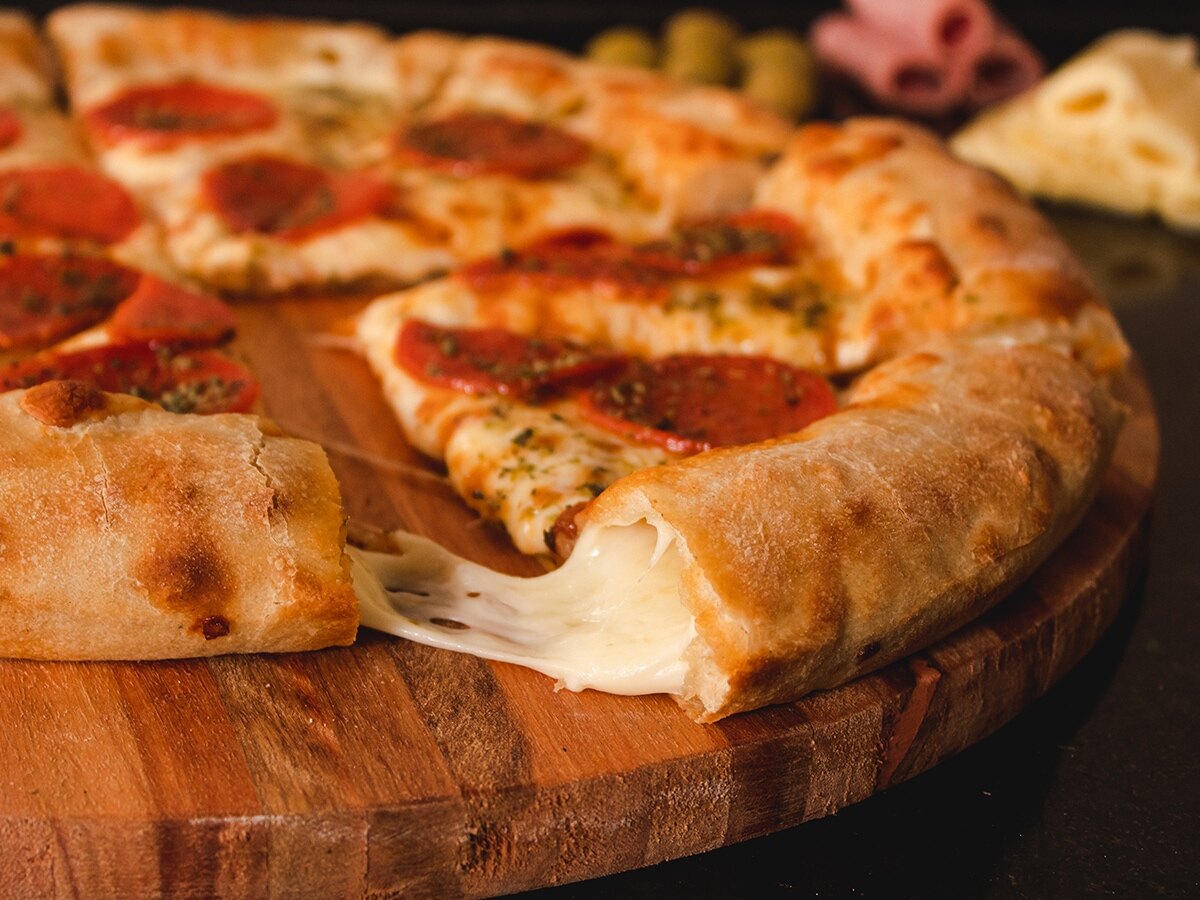 stuffed crust pizza on a wooden cutting board